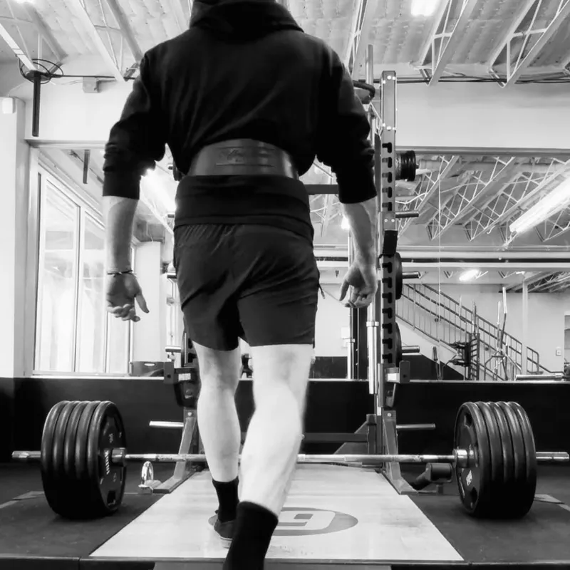 Maverick Strength Co. client in gym with branded apparel