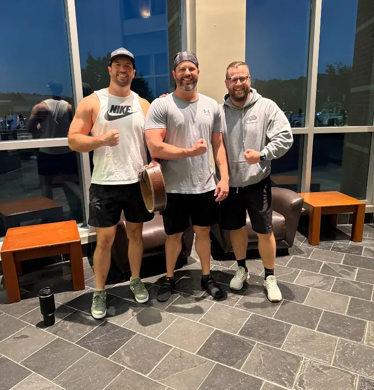 Maverick Strength Co. clients Tom and Matt celebrating together at the gym